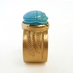 turquoise carved scarab set in 18 kt gold with hand engraved details of ancient egyptian wing motif