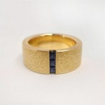 Princess cut sapphires channel set in 18 kt. gold ring