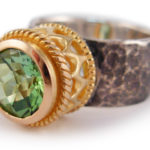 Green tourmaline set in 18 karat gold and sterling silver