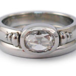 Oval rose cut in 19 karat white gold with pebble accents.