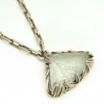 Carved aquamarine set in oxidized sterling silver. Tangled Garden pendant
