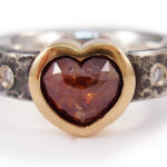 Heart shaped red rose cut diamond with gypsy set diamonds in 18 karat gold and Sterling silver.