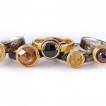 Selection of coloured rose cut diamonds set in 18 kt. gold and sterling silver