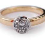 Brilliant cut diamond set in 19 white gold and 18 kt. yellow gold