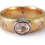Rose cut oval shape diamond set in 19 kt. white gold and 18 kt. yellow gold