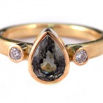 Green sapphire pear shape and brilliant cut diamonds set in 18 kt. gold ring